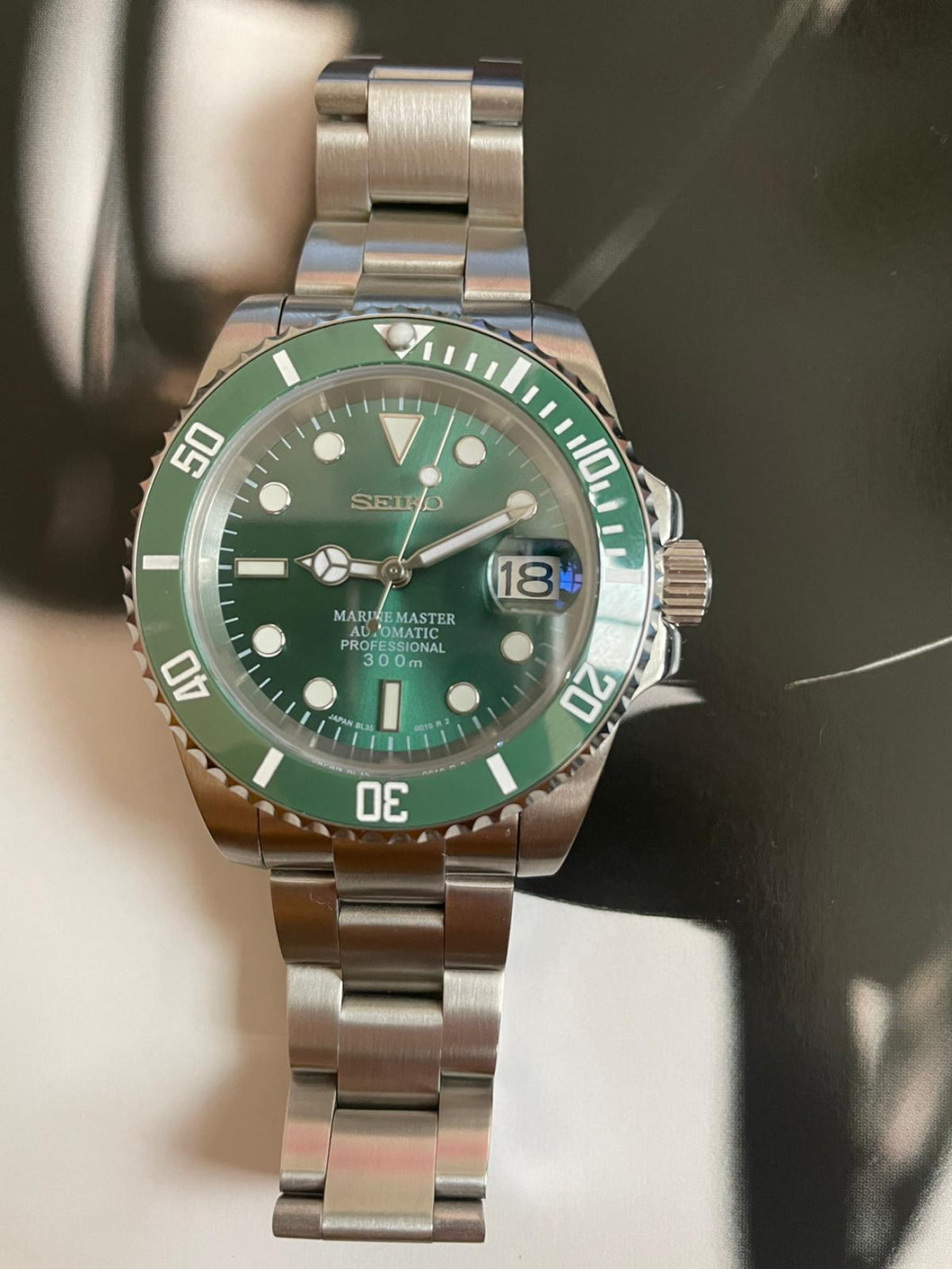 Green ceramic bezel sunburst green dial automatic watch